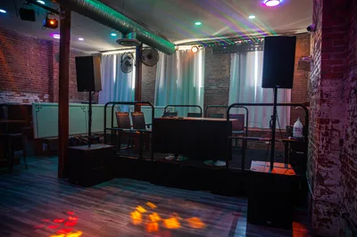 Seating and booths along the exposed brick wall